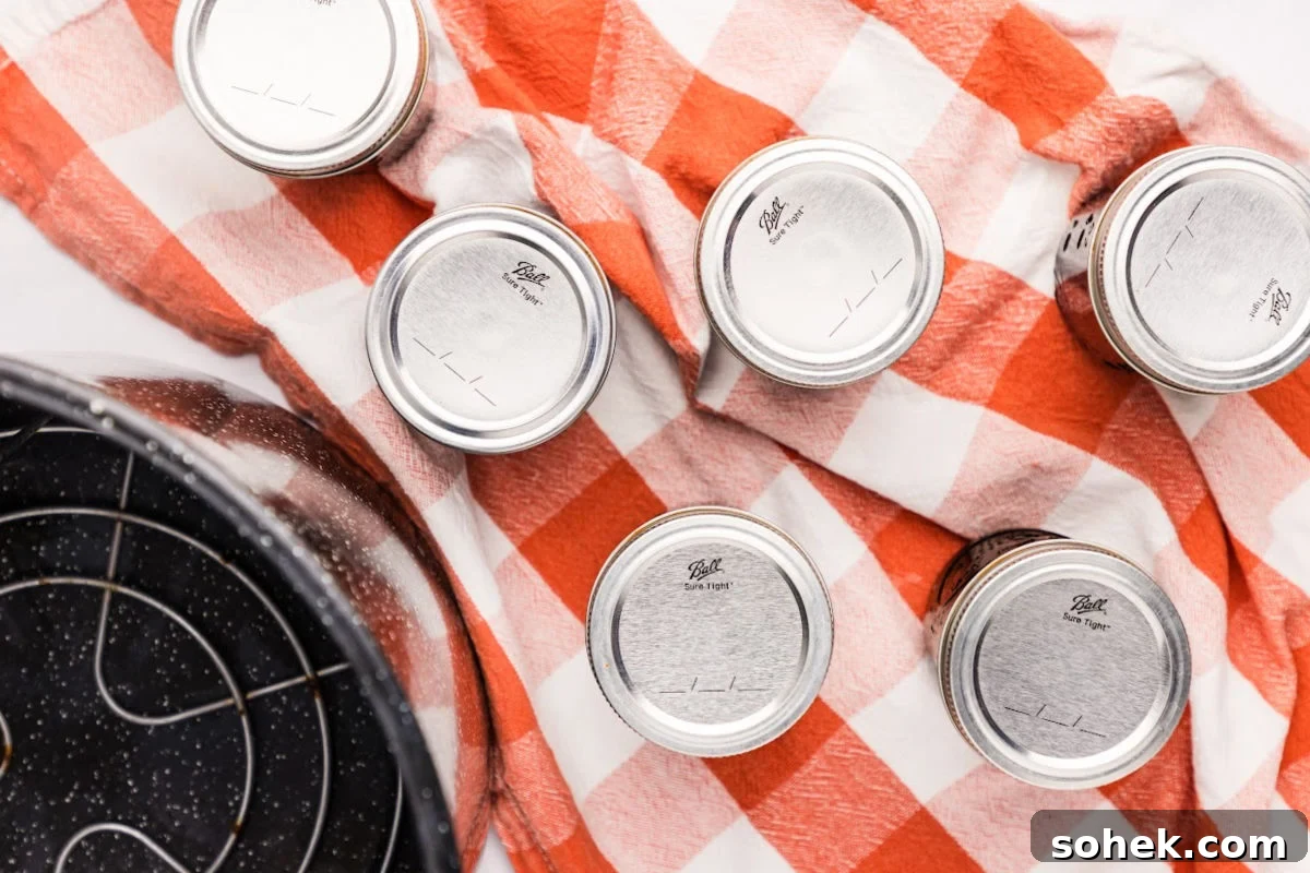 jars cooling on red and white towel.