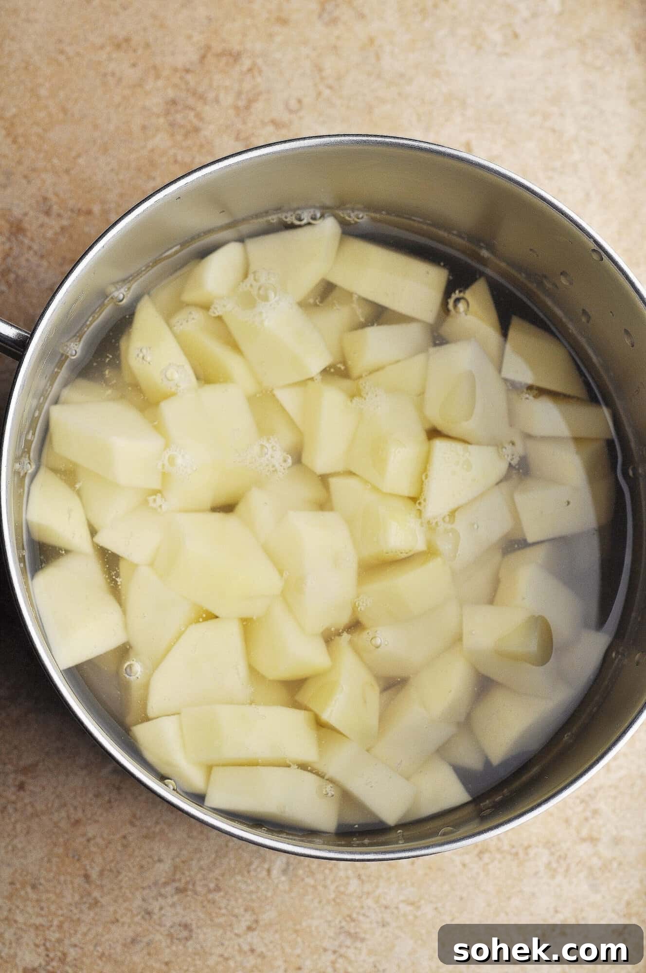 Potatoes in pot covered with water