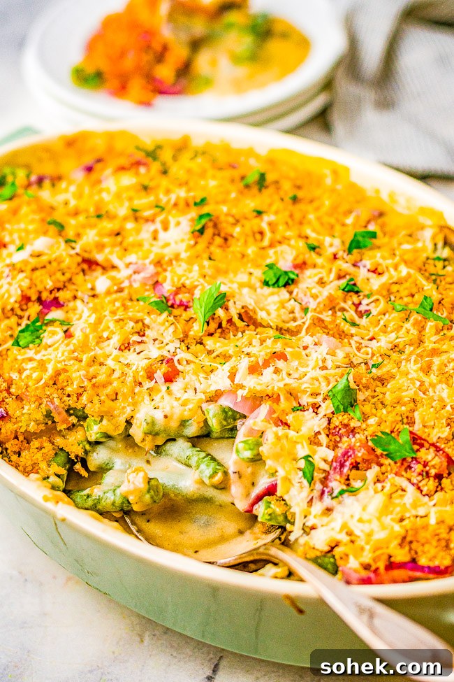Classic Green Bean Casserole Recipe for Holiday Dinner 2 A large green casserole dish full of green bean casserole.