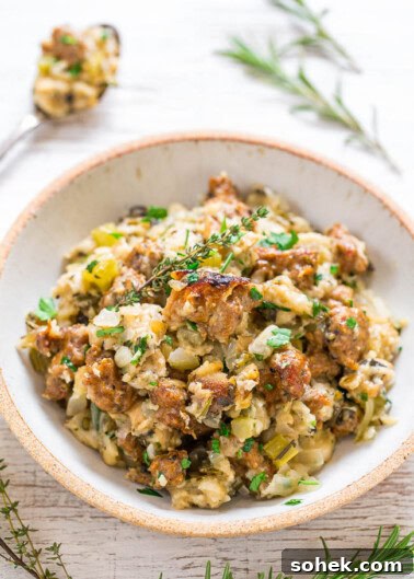Classic Green Bean Casserole Recipe for Holiday Dinner 15 A bowl of stuffing garnished with fresh herbs.