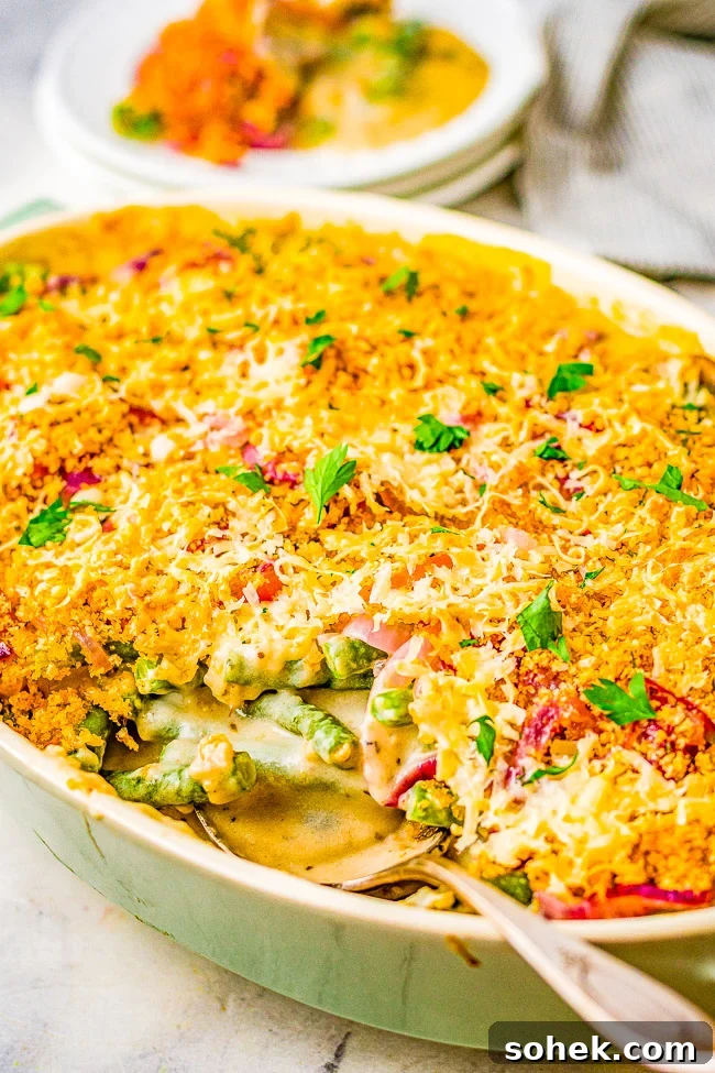 Classic Green Bean Casserole Recipe for Holiday Dinner 21 Best Green Bean Casserole in a baking dish with a spoon sticking out.