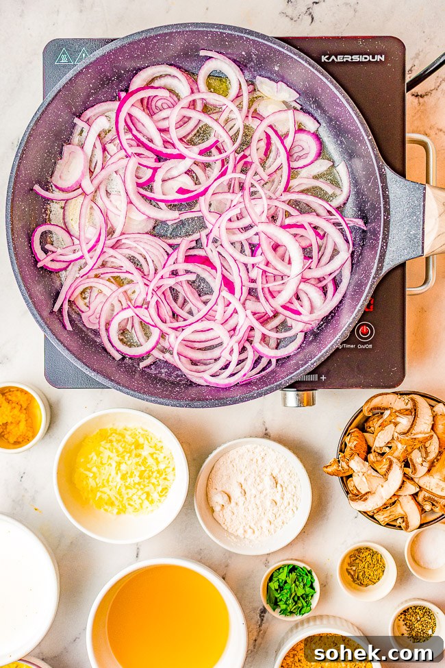 Classic Green Bean Casserole Recipe for Holiday Dinner 5 Process shot of red onions being sautéed in a skillet.