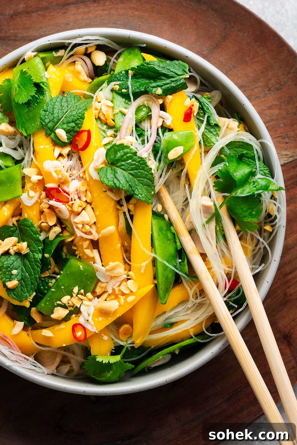 Spicy Thai Green Mango Salad (Yam Ma Muang) — Tangy Mango Thai Salad 11 Thai mango salad served with glass noodles and more vegetables for an easy mango noodle salad.