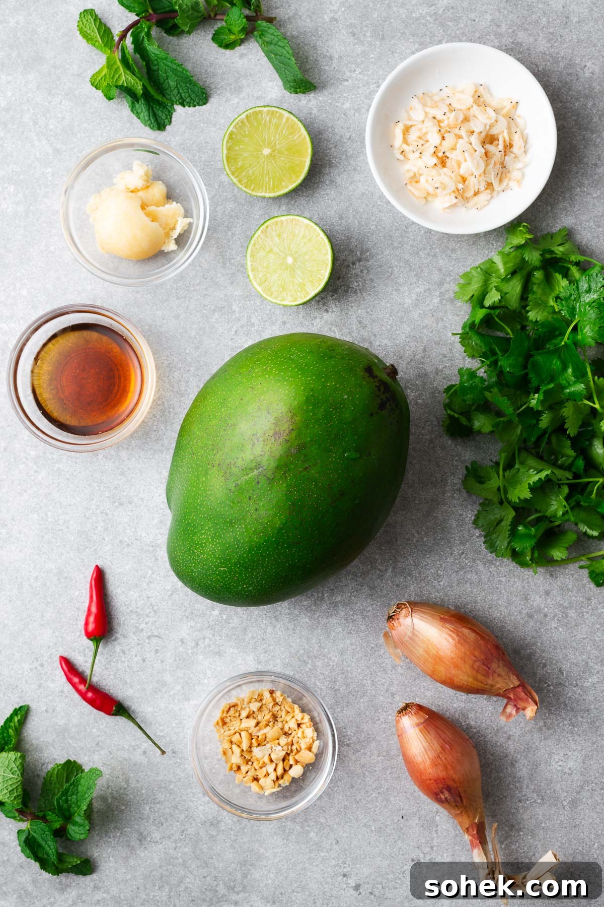 Spicy Thai Green Mango Salad (Yam Ma Muang) — Tangy Mango Thai Salad 3 Ingredients for Thai green mango salad including a green unripe mango, fish sauce, palm sugar, lime juice, shallots, cilantro, shallots and dried shrimp.