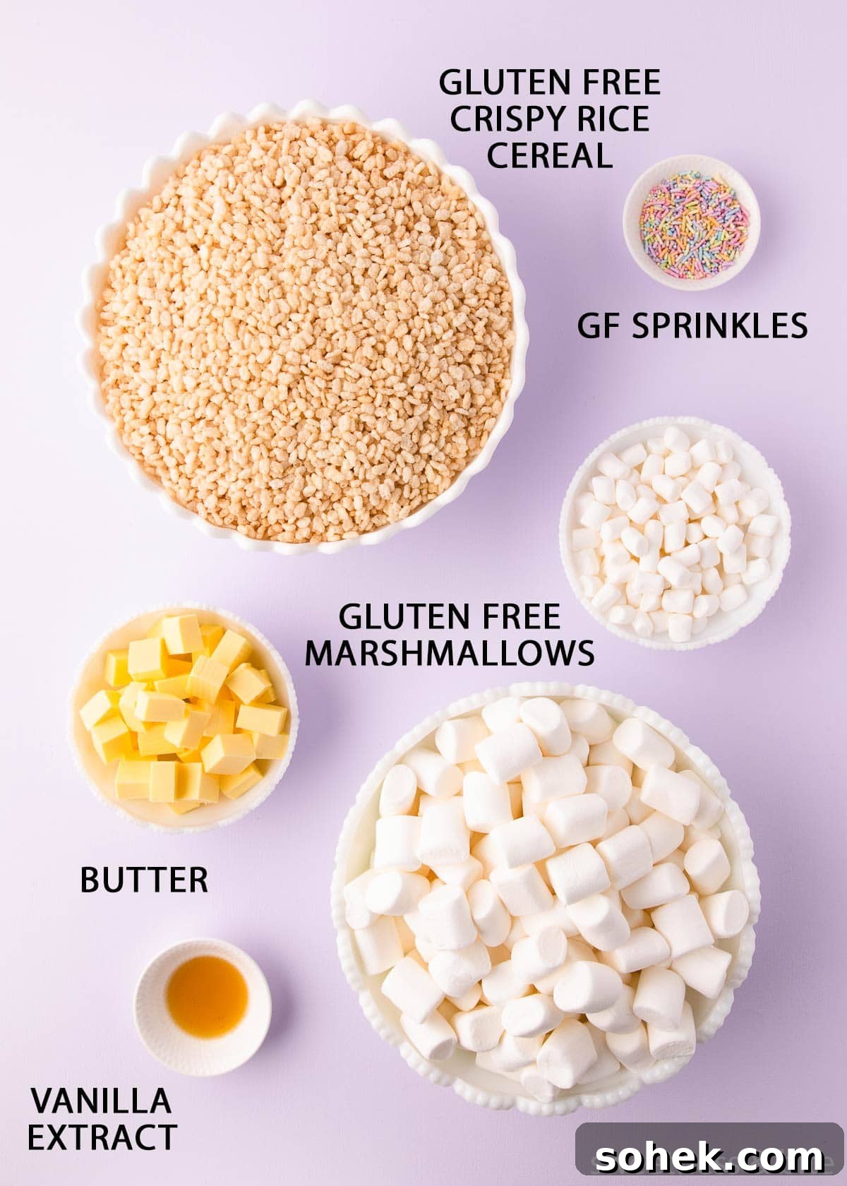 Gluten-Free Rice Krispie Treats Recipe — Crispy & Chewy Bars 4 The ingredients in white bowls on a light purple background with labels in black uppercase text.