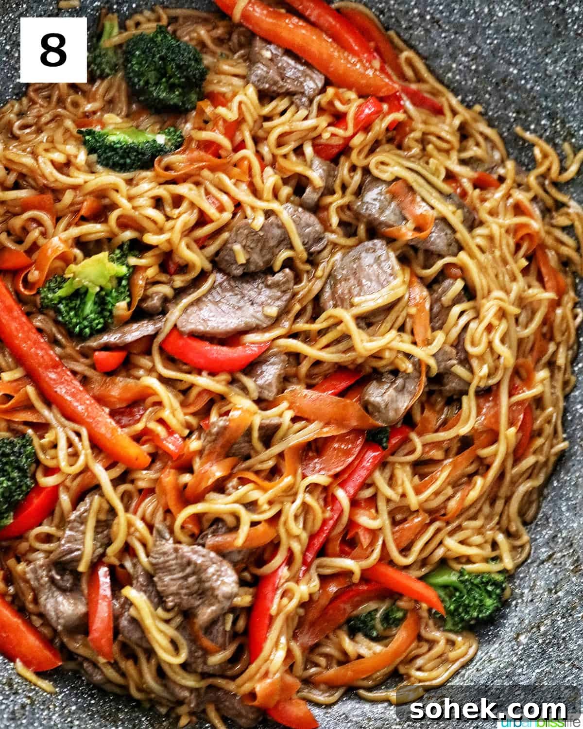 Sesame Garlic Noodles with Steak in a large wok.