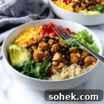 Tofu Burrito Bowls in a white bowl with a fork.