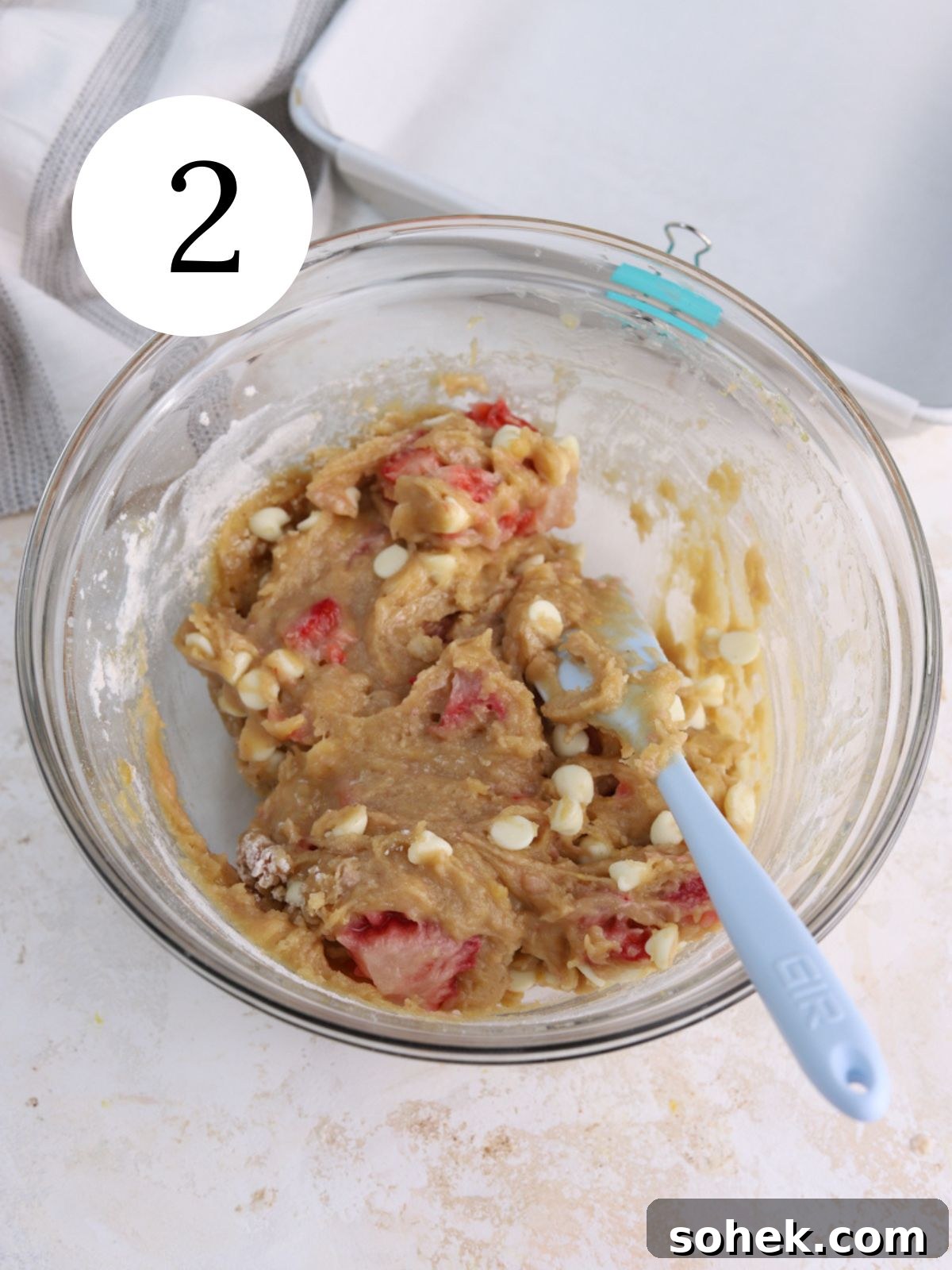 Blondie batter in a bowl next to a pan