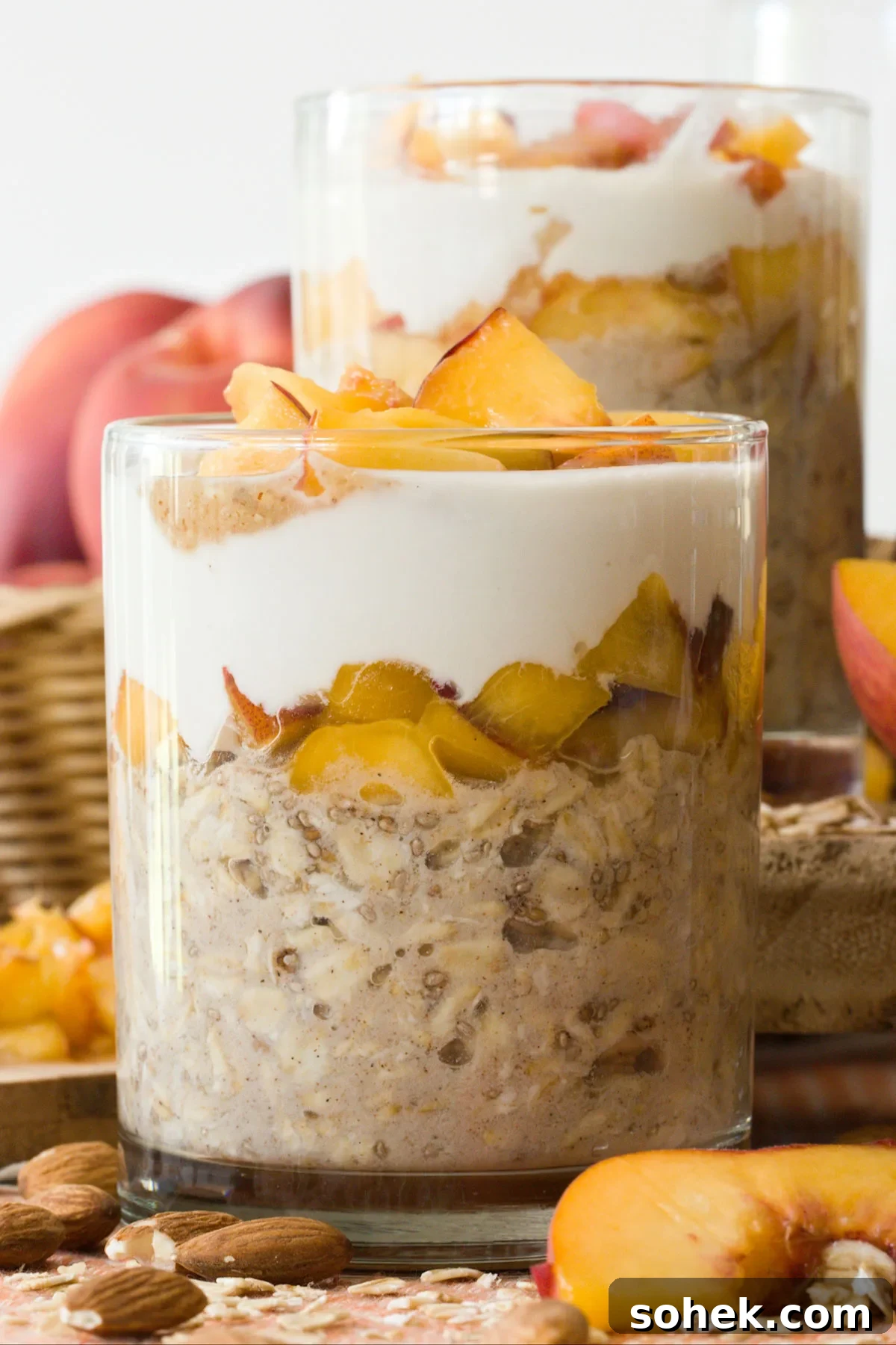 Close-up of a glass filled with peaches & cream overnight oats.