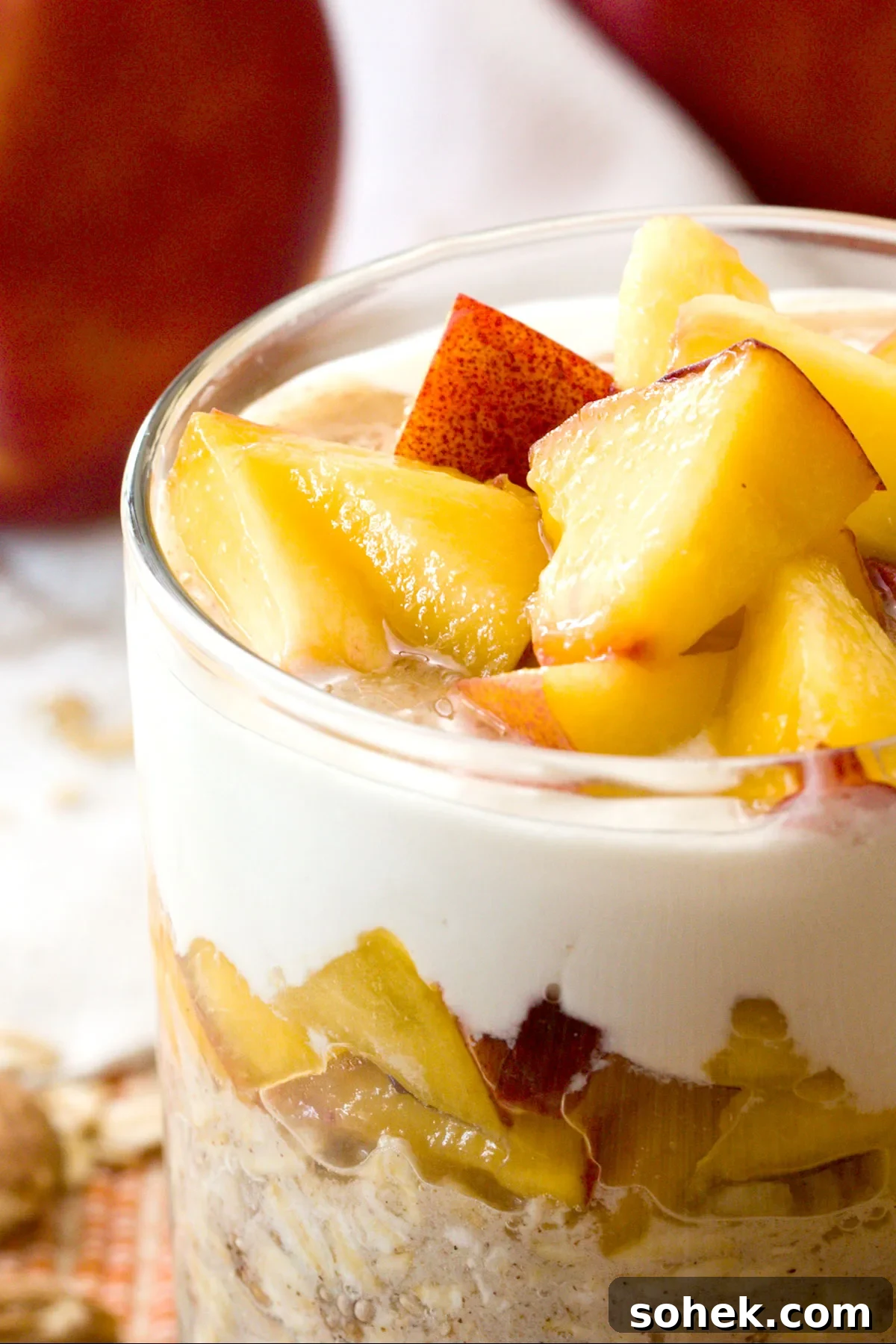 Close-up of chopped peaches on top of peaches & cream overnight oats.