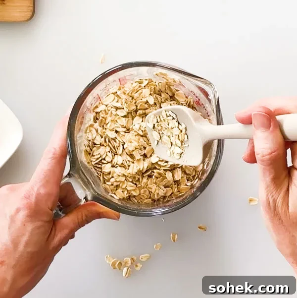 Mixing the oats with the melted butter in the bowl.