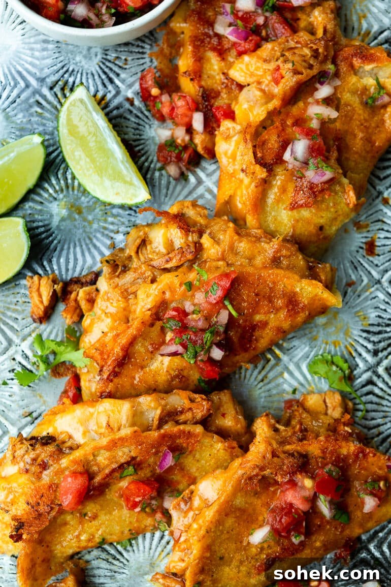 Weekly Meal Plan: October 2–8 (7-Day Menu Guide) 3 a photo of several birria chicken tacos on a metal tray topped with fresh pico de gallo