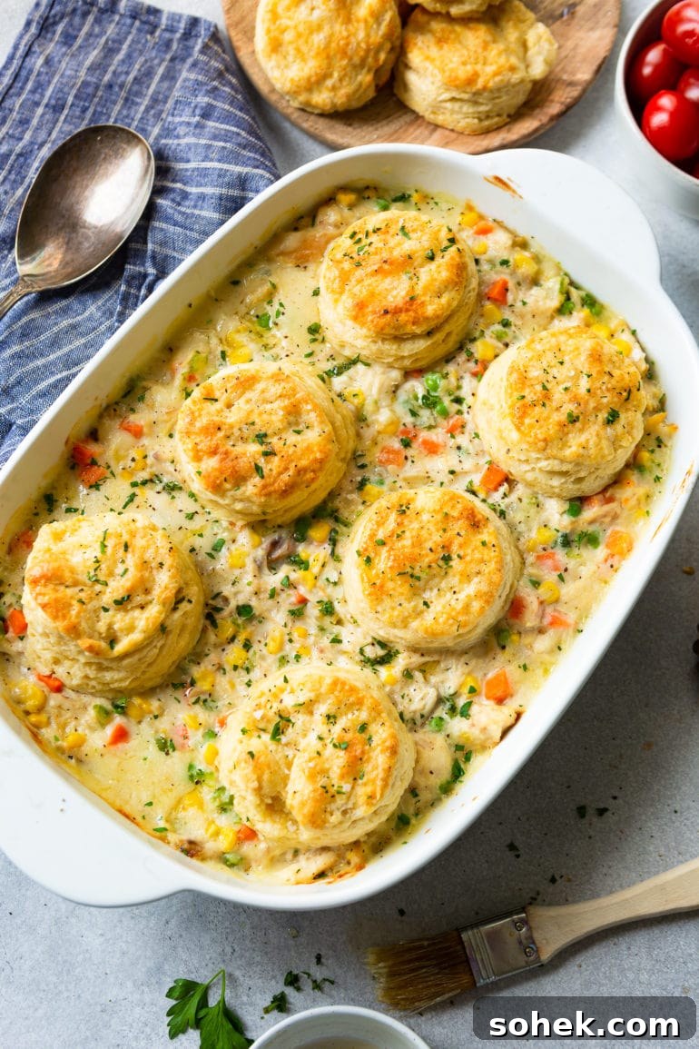 Weekly Meal Plan: October 2–8 (7-Day Menu Guide) 6 a photo of a white rectangular baking dish full of creamy chicken pot pie filling with six golden butter milk biscuits on top.