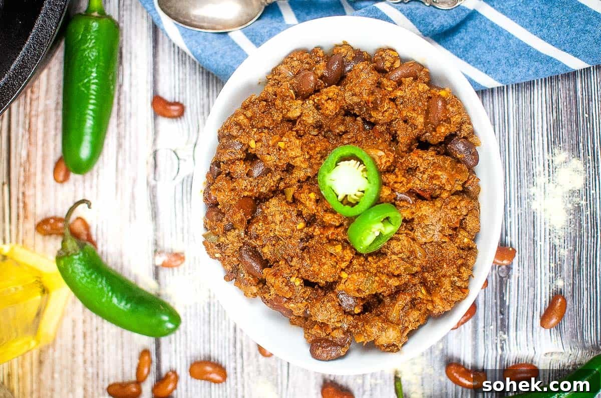 21 Quick Ground Beef Dinners That Will Have Everyone Asking Your Secret 16 A bowl of Texas roadhouse chili with jalapenos and beans.