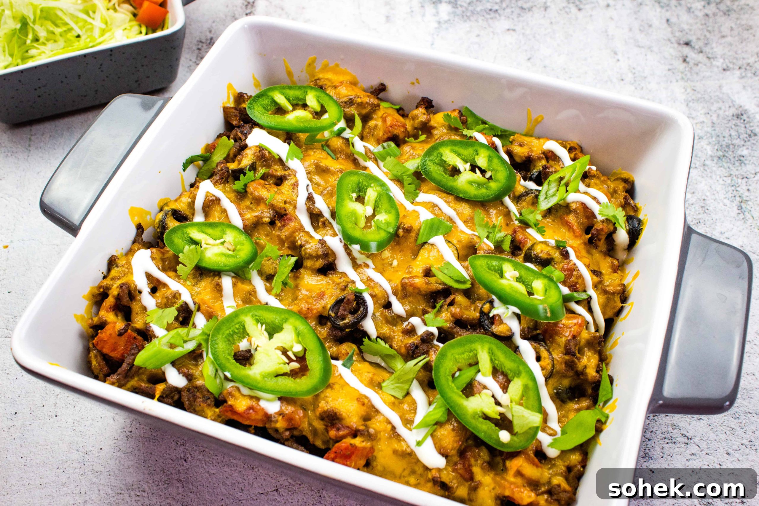 21 Quick Ground Beef Dinners That Will Have Everyone Asking Your Secret 18 A Taco Casserole dish with black beans, cheese and jalapenos.