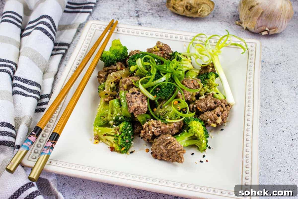 21 Quick Ground Beef Dinners That Will Have Everyone Asking Your Secret 19 A plate of beef and broccoli with chopsticks.