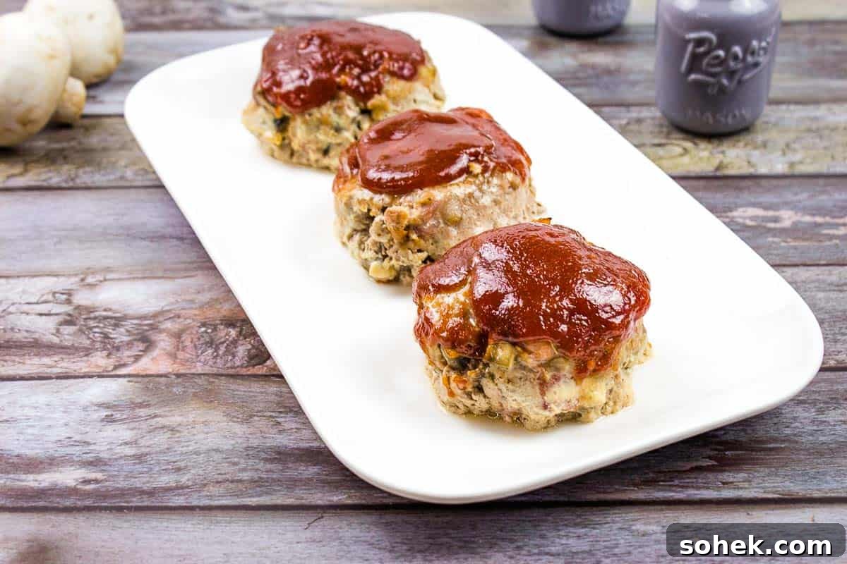 21 Quick Ground Beef Dinners That Will Have Everyone Asking Your Secret 21 3 Mini Meatloaves in a line on a white plate.
