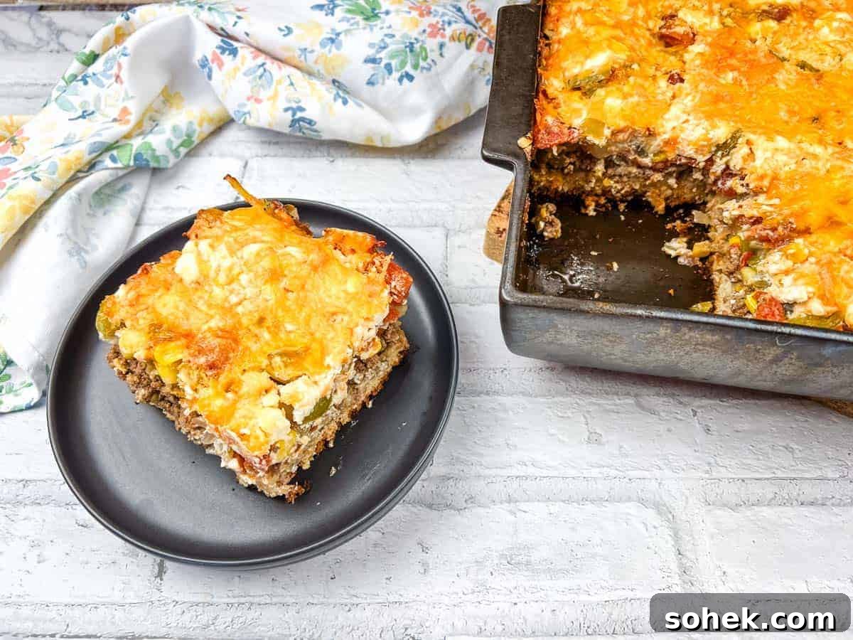 21 Quick Ground Beef Dinners That Will Have Everyone Asking Your Secret 7 A slice of John Wayne casserole on a black plate beside a baking dish of the same casserole.