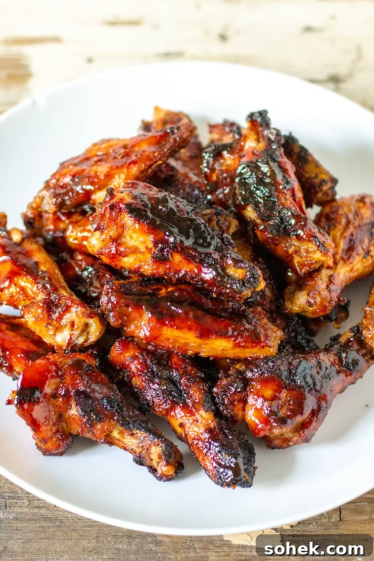 Overhead of grilled chicken wings on serving plate.