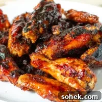 Maple bourbon grilled chicken wings on a serving plate.