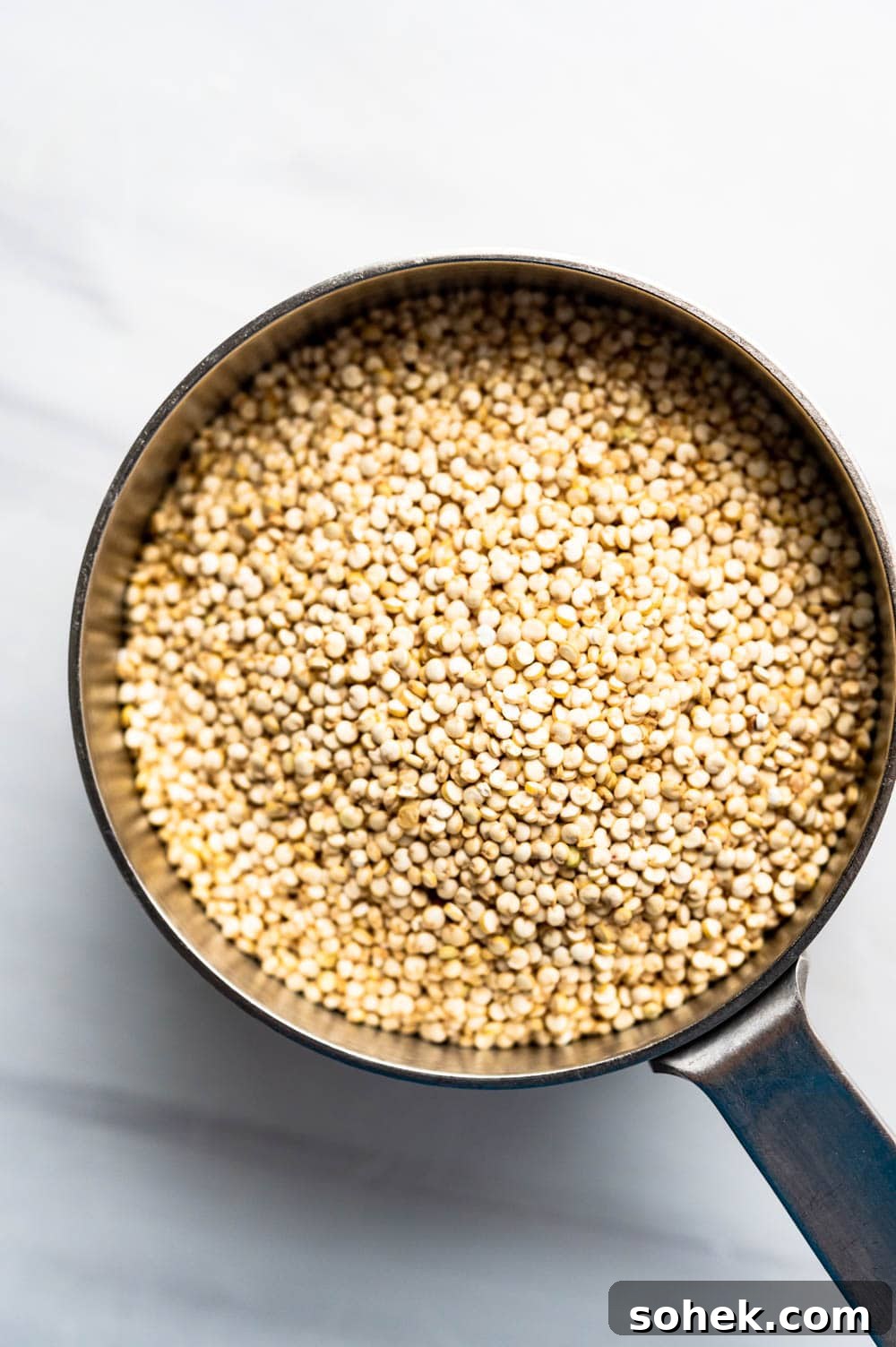quinoa in a measuring cup.
