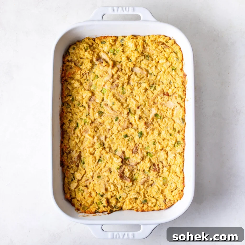 chicken and cornbread dressing in a white casserole dish after being baked