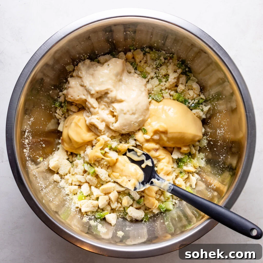 folding cream of chicken and celery into the cornbread and sautéed vegetables. 