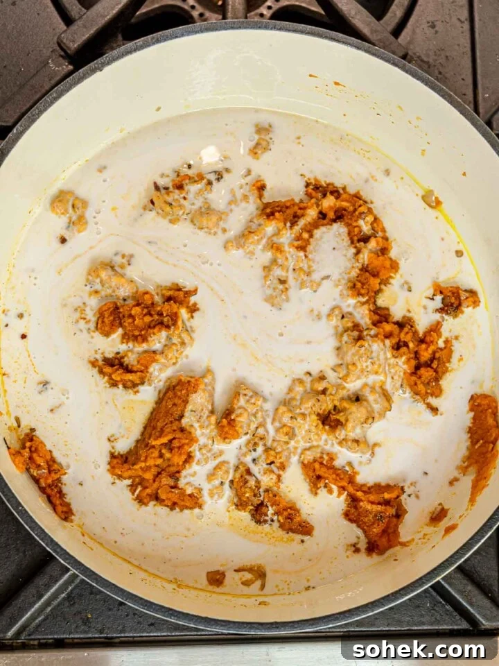 Creamy Pumpkin Pasta Sauce Recipe: Vegan, Savory Fall Dinner 6 Pumpkin puree and spices combined with creamy coconut milk in a pot.
