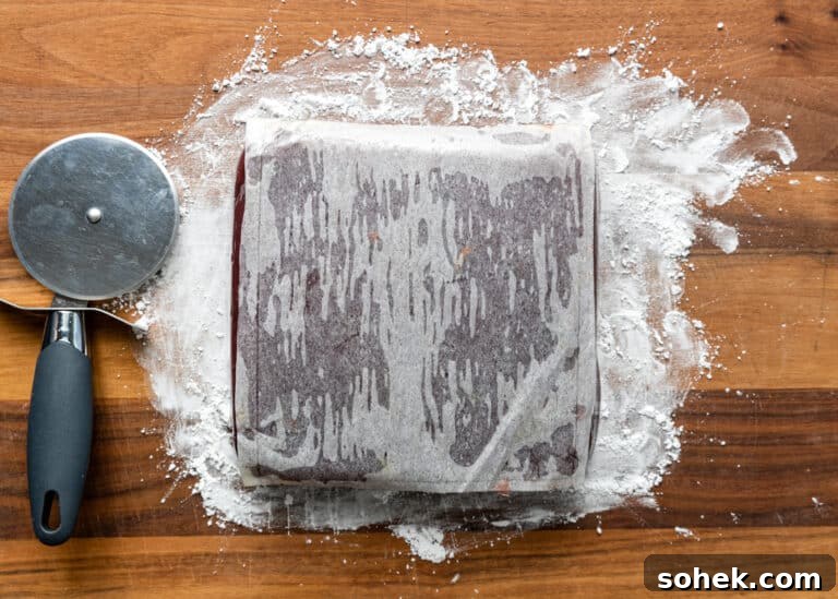 Authentic Turkish Delight (Lokum) Recipe for Soft, Chewy Sweets 16 turkish delight covered with parchment paper