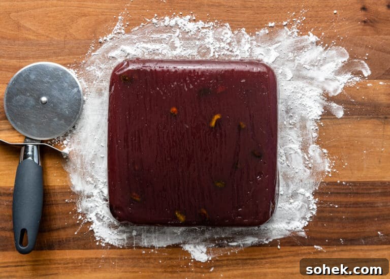 Authentic Turkish Delight (Lokum) Recipe for Soft, Chewy Sweets 17 homemade pomegranate gelatin candy on wood cutting board