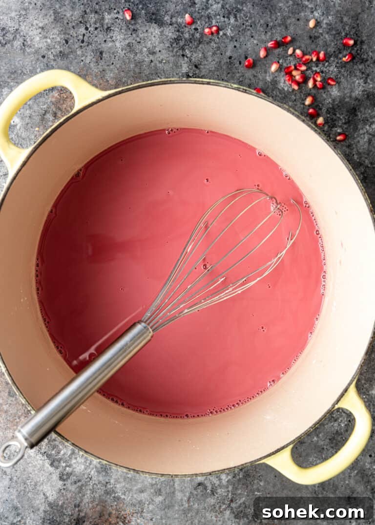 Authentic Turkish Delight (Lokum) Recipe for Soft, Chewy Sweets 8 pink pomegranate mixture in dutch oven with whisk