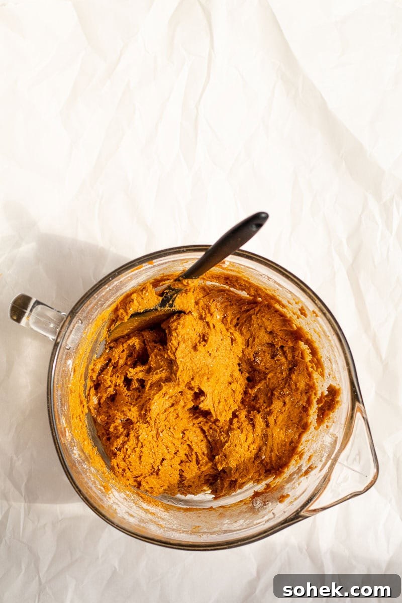 pumpkin bread batter in a glass mixing bowl