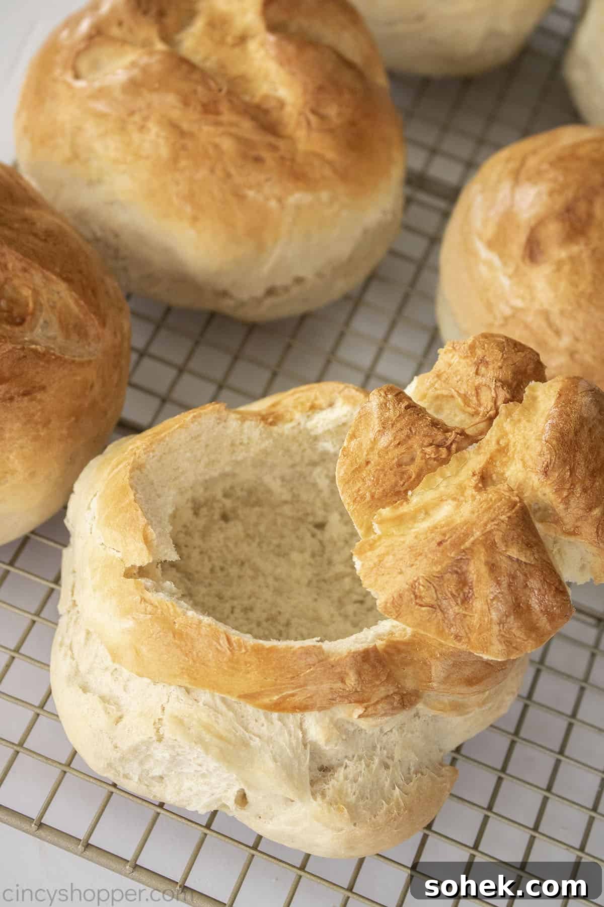 How to Make Homemade Bread Bowls for Soup and Dips 3 Homemade bread bowls on a wire rack.