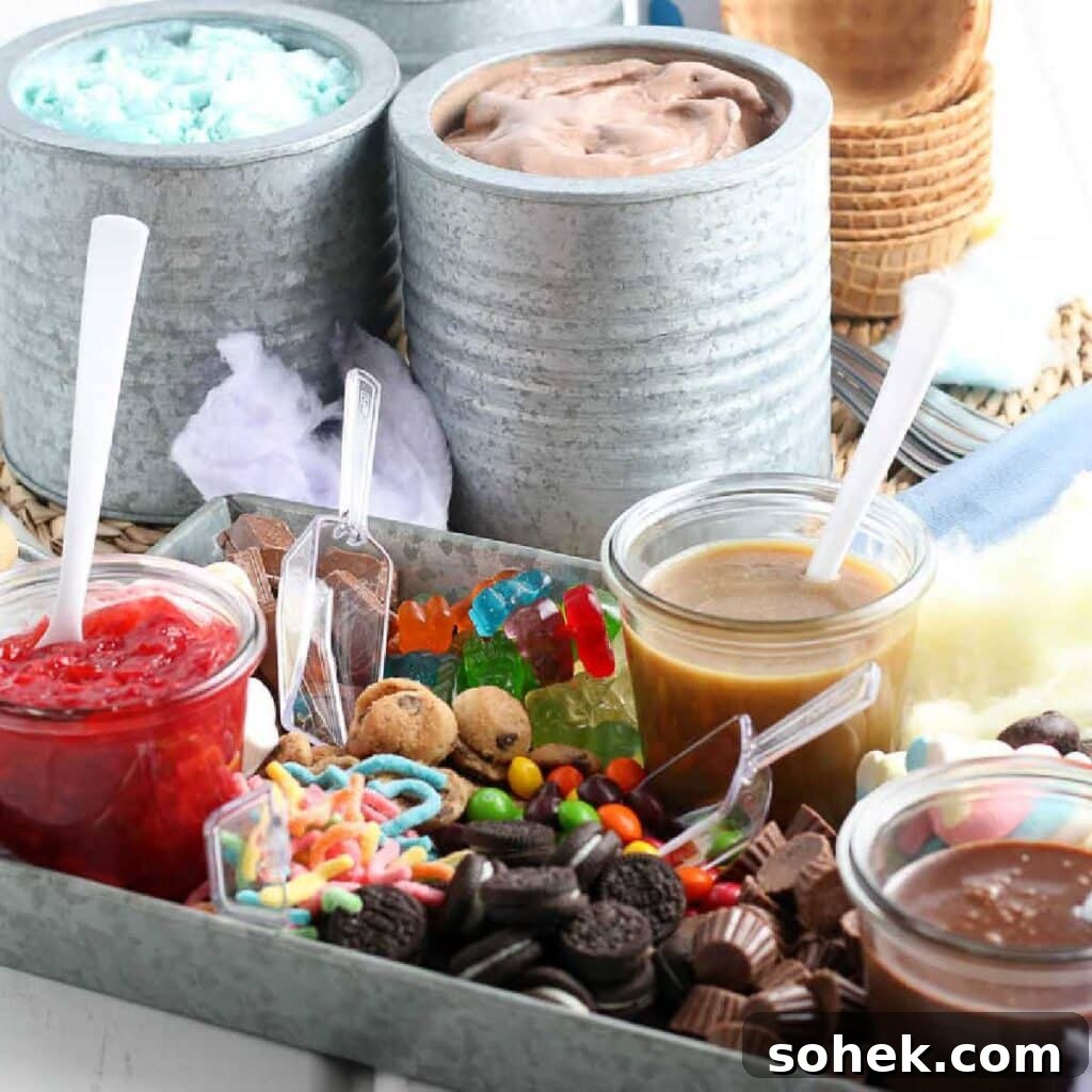 DIY Ice Cream Sundae Bar Ideas for Parties and Gatherings 2 Metal serving tray filled with ice cream sauces and toppings with scoops and canisters of ice cream in the background.