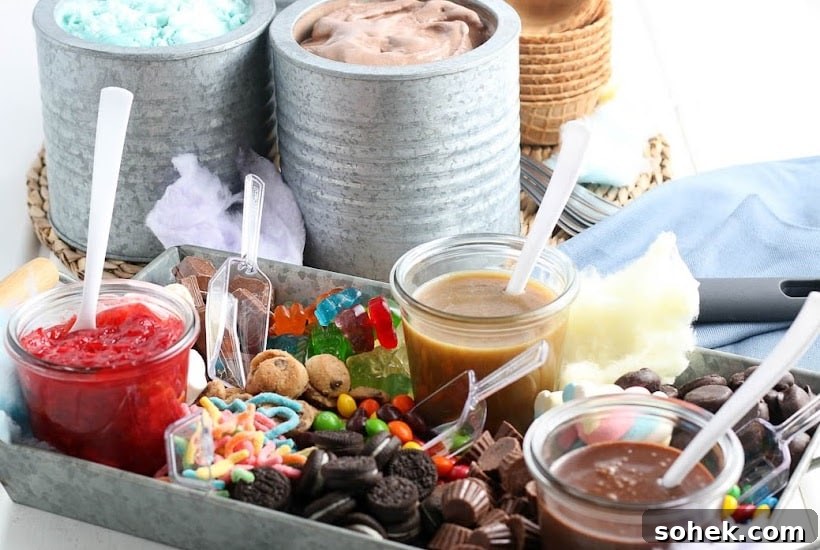 DIY Ice Cream Sundae Bar Ideas for Parties and Gatherings 9 Metal tray filled with ice cream sauces and toppings with canisters of ice cream in the background.