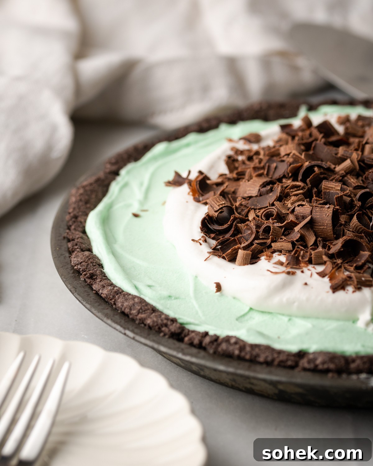 No-Bake Chocolate Mint Pie Recipe: Creamy No-Bake Mint Chocolate Pie 2 A chocolate mint pie with whipped cream and chocolate curls on top.