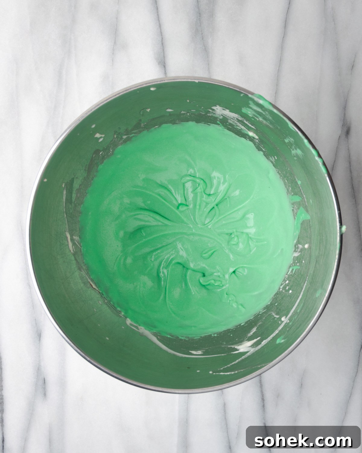 No-Bake Chocolate Mint Pie Recipe: Creamy No-Bake Mint Chocolate Pie 7 Green pie filling in a mixing bowl.