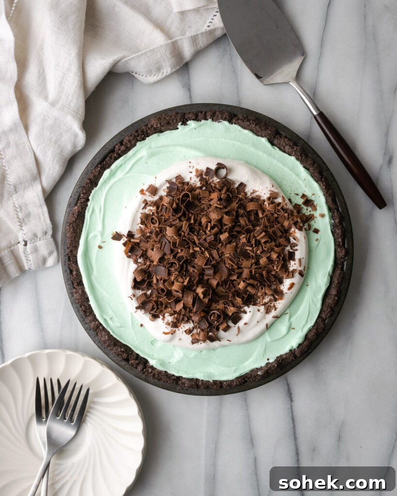 No-Bake Chocolate Mint Pie Recipe: Creamy No-Bake Mint Chocolate Pie 10 A chocolate mint pie sitting on a white marble table.