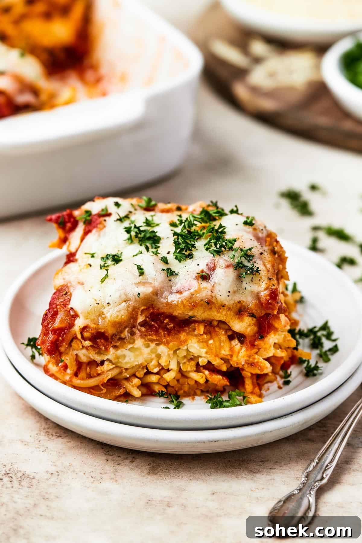 A square of baked spaghetti on a plate.