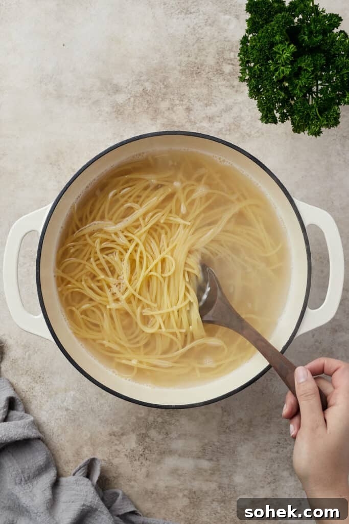 Pasta boiling in a Dutch oven.