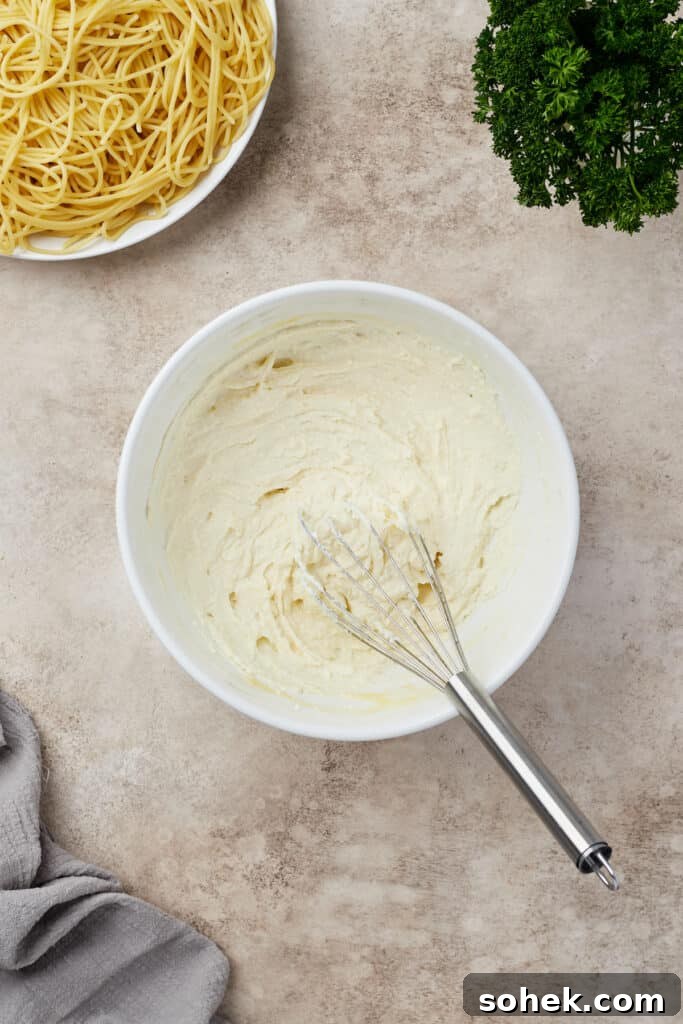 Ricotta and egg whisked together in a mixing bowl.