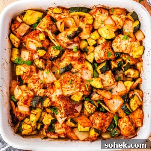 A close-up picture of the chicken and zucchini baked in a casserole dish.