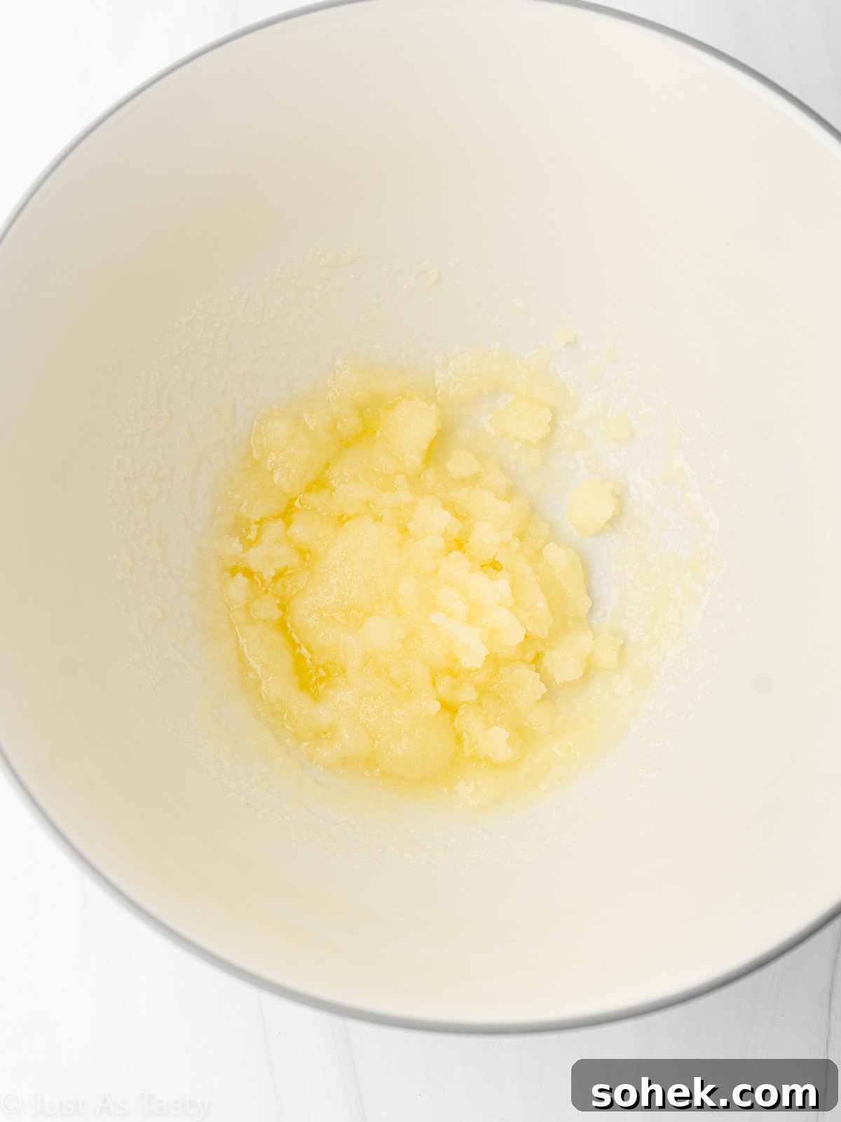 Melted butter and sugar in a bowl.