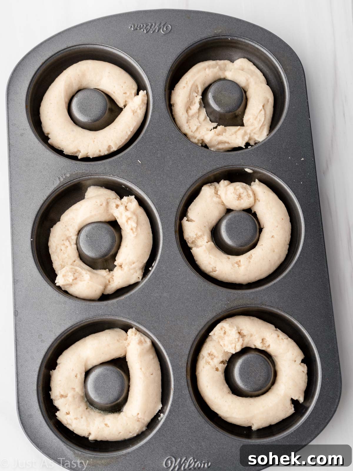 Donut batter in a donut pan.