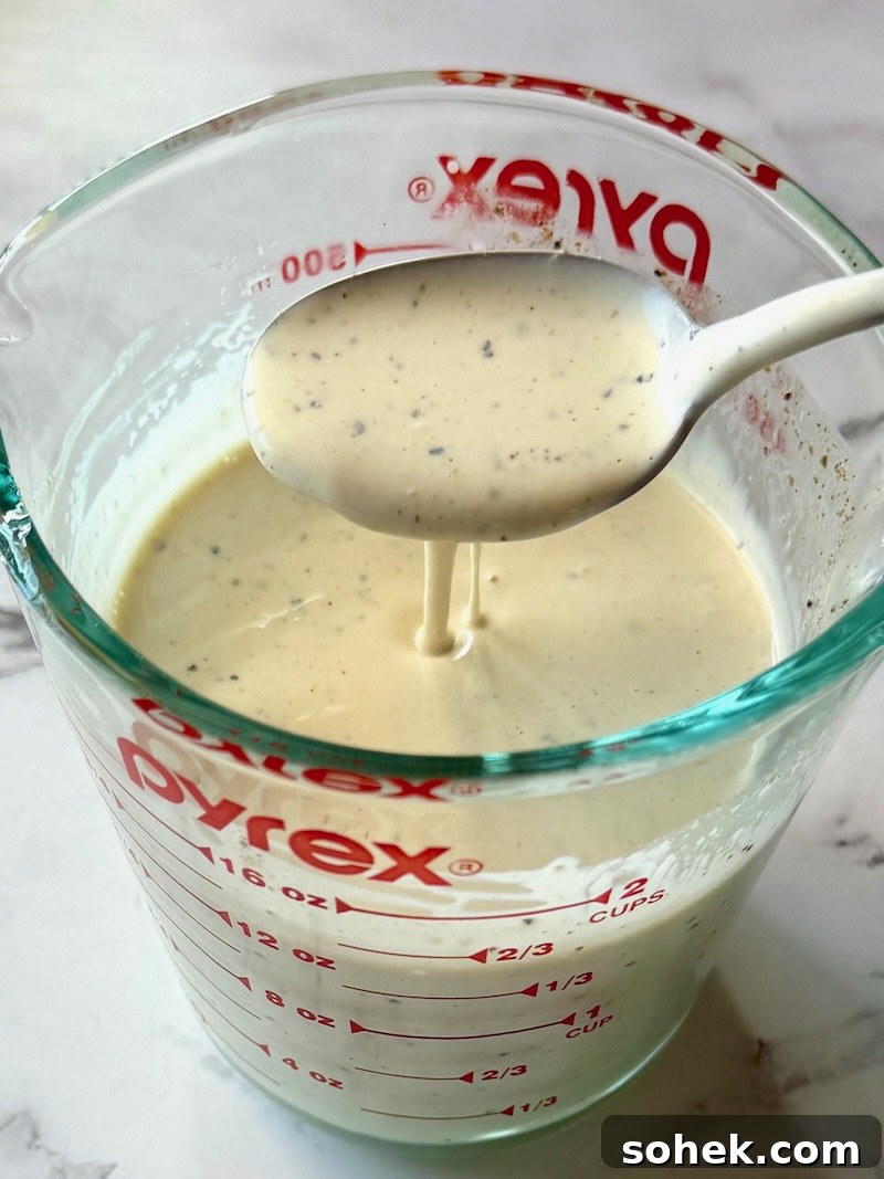 Dressing combined in a measuring cup with a spoon