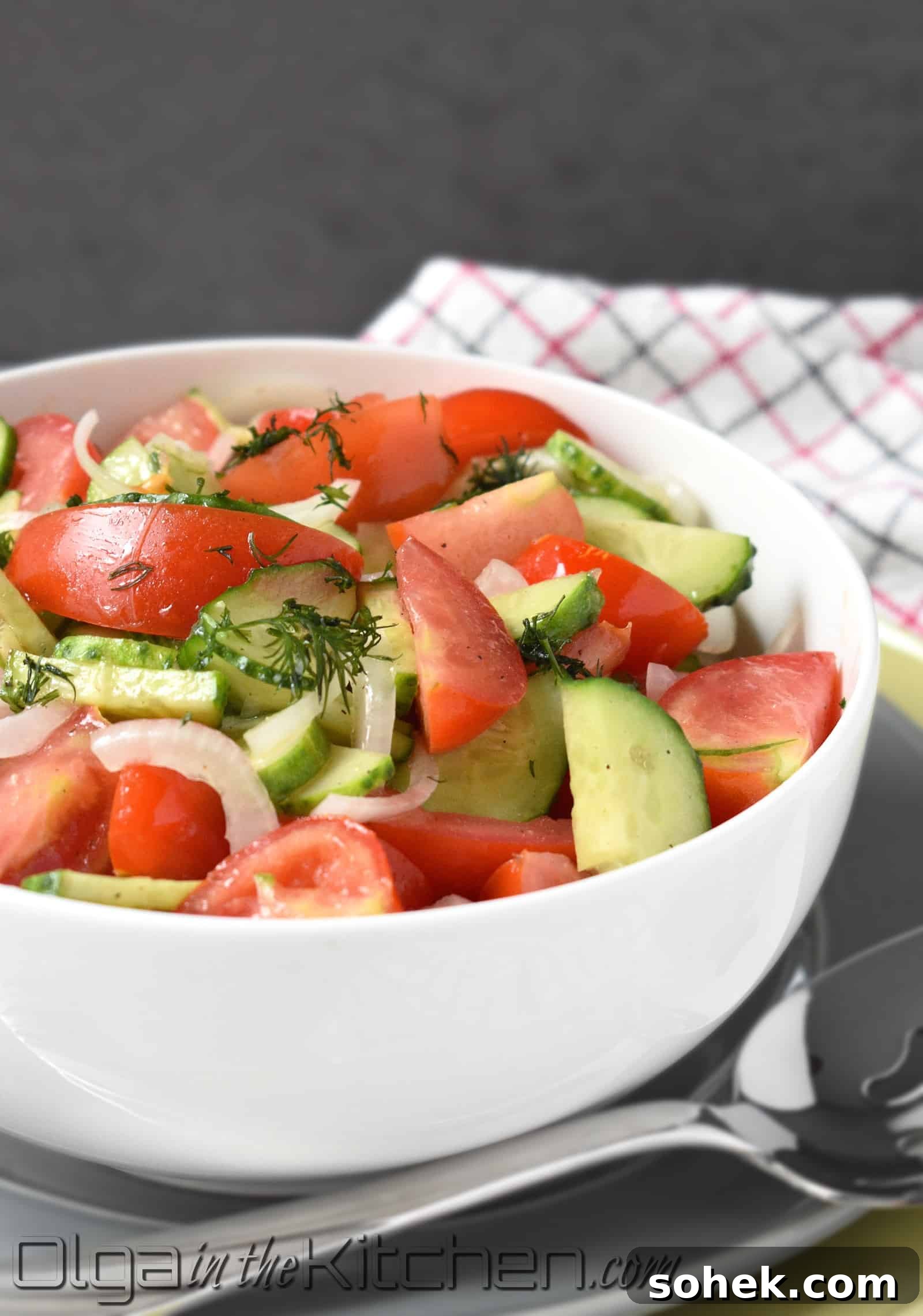 Tomato and cucumber salad served with accompaniments.