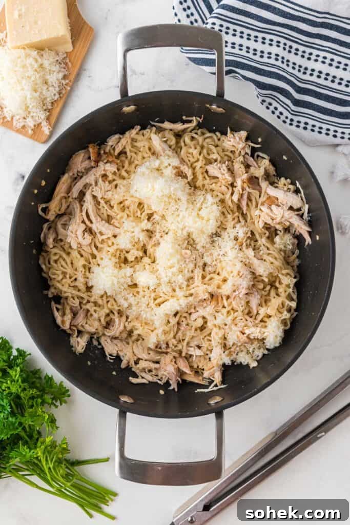 Finished garlic parmesan chicken ramen in a skillet, ready to serve