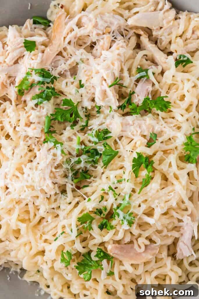 Close up of garlic parmesan chicken ramen garnished with parsley