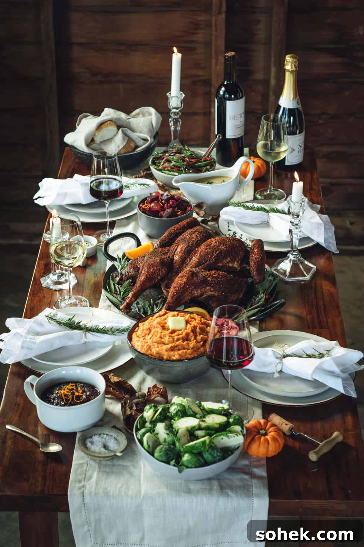 smoked spatchcocked turkey on a full thanksgiving feast table