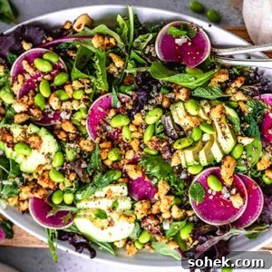 Overhead view of Seasonal Salad with Baked Lemon Tofu Bits on a white oval platter